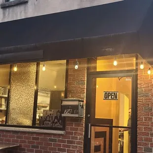 a brick building with a black awning