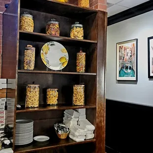 a shelf of pasta and other food items