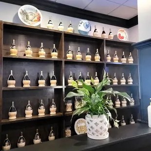 a shelf of cupcakes and a potted plant