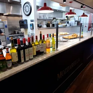 a counter with a variety of bottles of wine