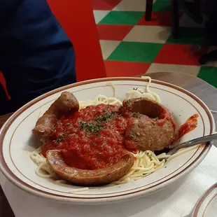 Spaghetti with marinara sauce and sliced sausage