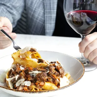 PAPPARDELLE ALL'OSSOBUCO with pappardelle pasta tossed with shredded ossobuco, porcini, mushrooms &amp; shaved Pecorino Toscano