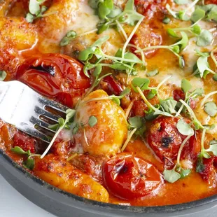 GNOCCHI SORRENTINA with baked gnocchi, San Marzano pomodoro Sauce, eggplants, Calabrian chili, mozzarella di bufula, parmigiano &amp; basil