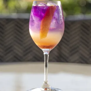 GIN SPRITZER; ramazzotti rosato, lemon, prosecco, butterfly pea-infused gin