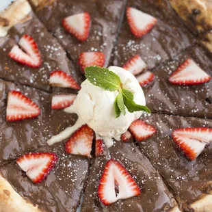 Pizza Con Nutella; Pizza topped with Nutella, pears, and cinnamon or banana and strawberries. Topped with a scoop of vanilla gelato