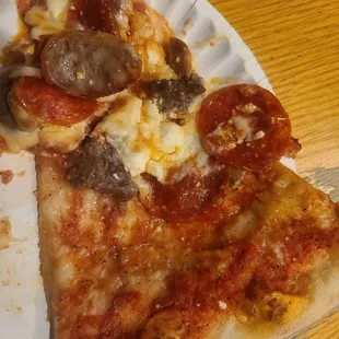 two slices of pizza on a paper plate