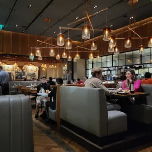 people sitting at tables in a restaurant