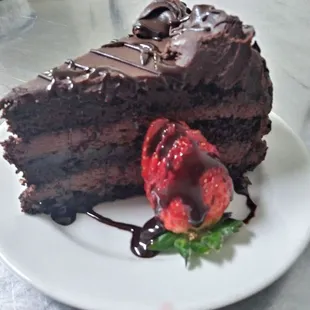 a piece of chocolate cake and a strawberry