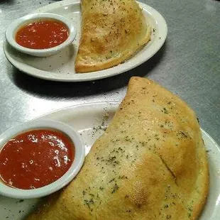 Calzone stuffed with ricotta and mozzarella cheese served with a side of marinara sauce.