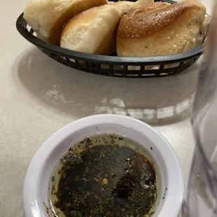 a basket of bread and dipping sauce
