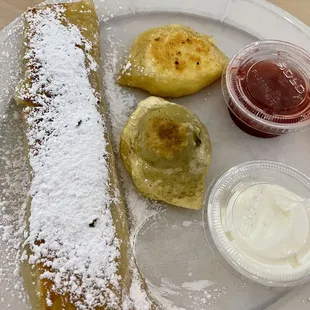 Part of the Polish combination plate: cheese crepe and perogies.