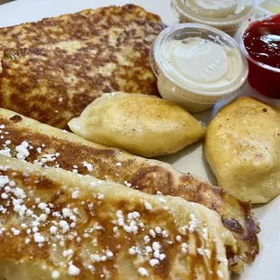 Polish meatless combo with 2 pierogi, 2 cheese crepes, and 2 potato pancakes. Strawberry sauce, sour cream, and applesauce on the side.