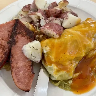 Part of the Polish combination plate with kielbasa, stuffed cabbage (galabki), and roasted red skin potatoes.