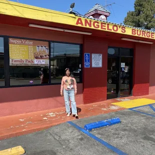 a woman standing in front of a restaurant