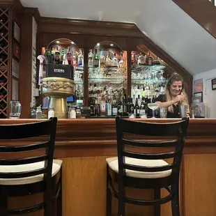 The bar, with someone mixing a drink for a customer.