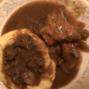 a plate of mashed potatoes and gravy