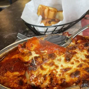 Manicotti with ricotta and Italian sausage and bread to accompany the meal