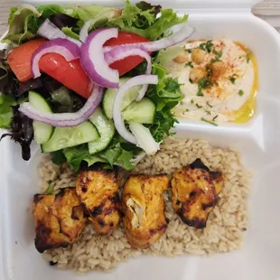Chicken kabob plate... Brown rice  portion was enough to cover the bottom of the tray... The hummus was a poor portion...