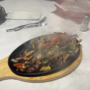 Chicken Fajitas. Came with rice and beans on a separate plate. Also, sour cream and guacamole.