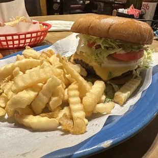 Delicious Cheese burger with all the fixings and fries.