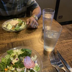 a plate of salad and a glass of water