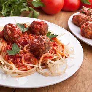 two plates of spaghetti and meatballs