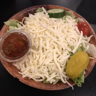 a salad with cheese and pickles