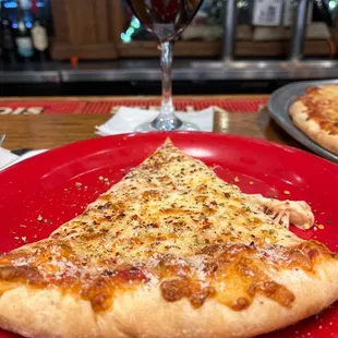 a slice of pizza on a red plate