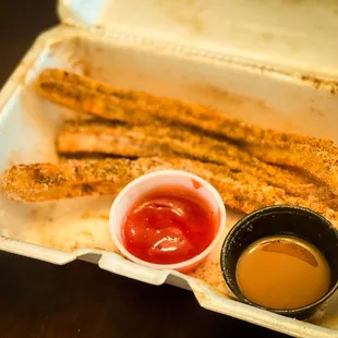 a box of churros and dipping sauce