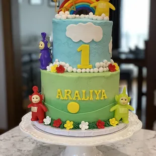 a birthday cake with a rainbow
