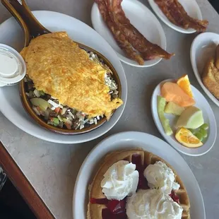 Gyro skillet, waffle with strawberry topping, fruit, bacon