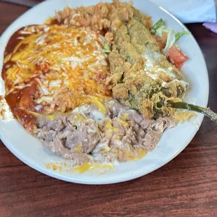 Enchiladas, chile relleno, rice and beans.
