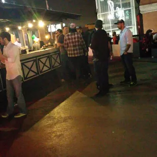 a group of people standing outside at night