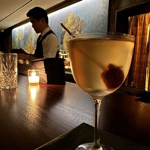 a glass of wine on a bar