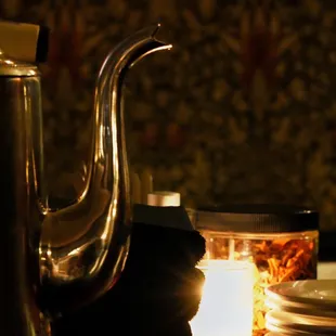 a teapot and a candle on a table