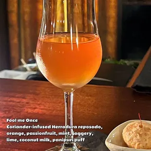 a glass of orange juice and a bowl of coconut milk