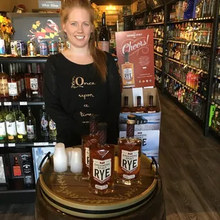 a woman standing behind a barrel