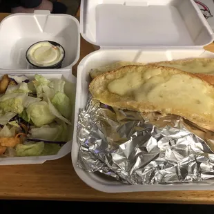 a salad in a styrofoam container