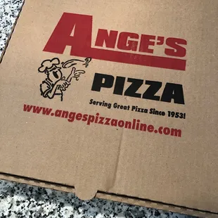 a pizza box on the ground