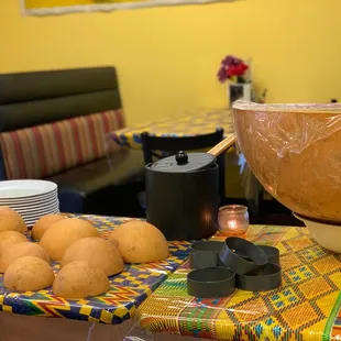 a table with a bowl of potatoes and a candle
