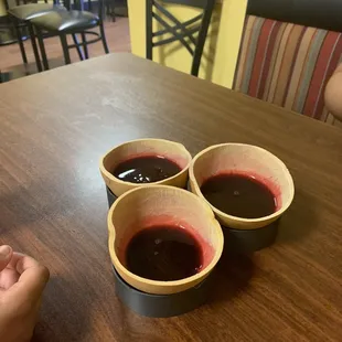 three cups of wine on a table