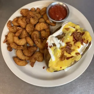 Shrimp, with a baked potato served with cheese, sour cream and bacon