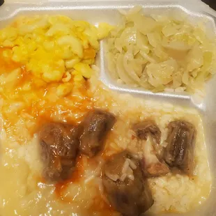 I was served these so called oxtails for $18. Yellow chicken gravy.  Cabbage had a fish grease taste. Very disappointed