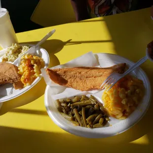 two plates of food on a yellow table