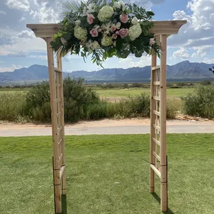 Wooden arch decoration with cascading flowers at Painted Dunes Golf Course