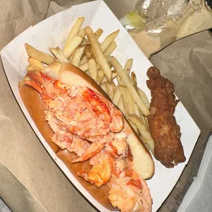 Lobster roll with fries and I added a fried half lobster tail! Comes with a pack of butter and Angie&apos;s sauce !