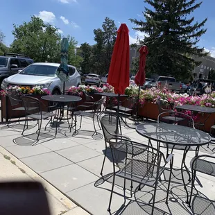 tables and chairs on the sidewalk