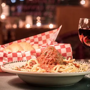 a plate of spaghetti and a glass of wine
