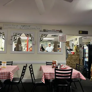 tables and chairs with red and white checkered tablecloths