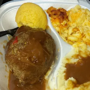 Salisbury steak dinner with mashed potatoes, mac n cheese and corn bread.